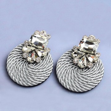 Rhinestone earrings on satin
