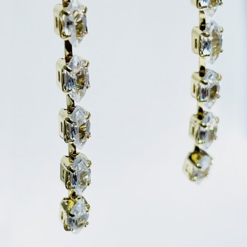Gold rhinestone drop earrings detail
