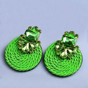 Rhinestone earrings on green satin