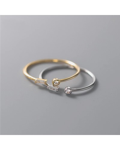 Thin open gold ring with 2 small zircons