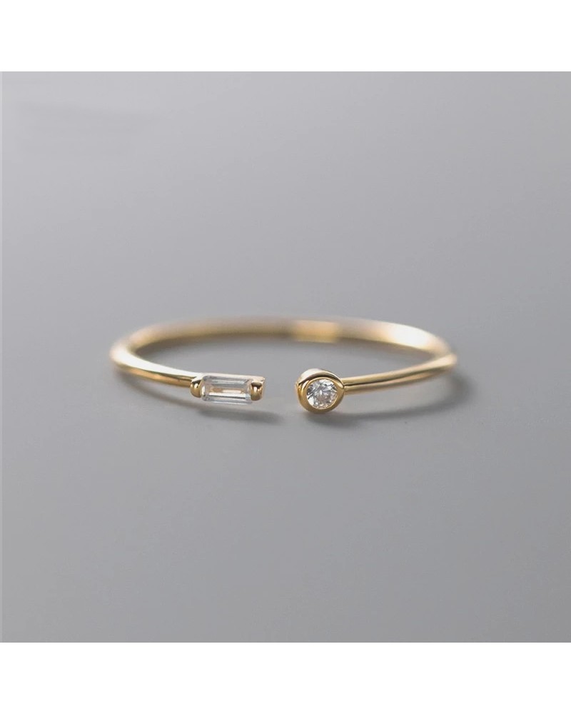 Thin open gold ring with 2 small zircons